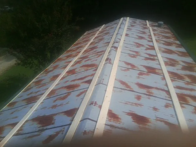 Rusted metal roof panels with new wood purlins before replacement — Storm Damage Roof Repair in Poynette by Roofing Brothers